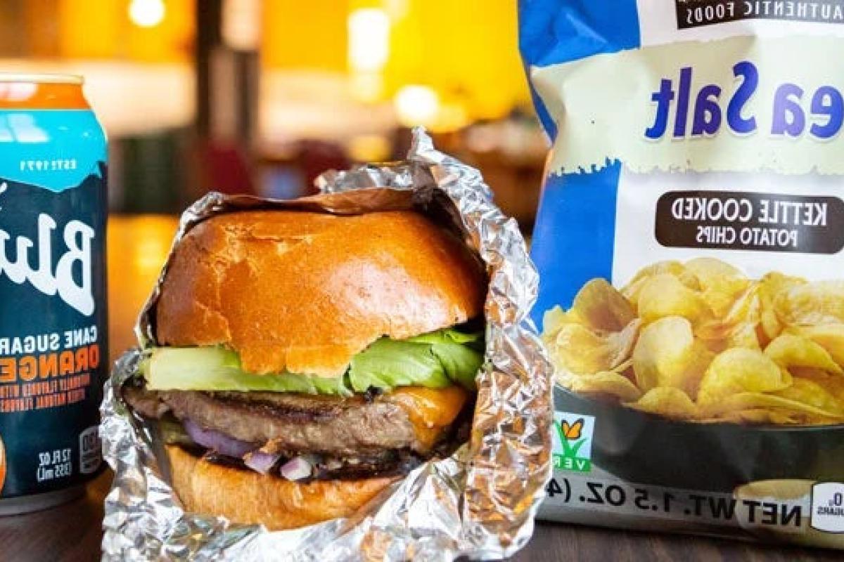 Takeout hamburger, chips and a drink