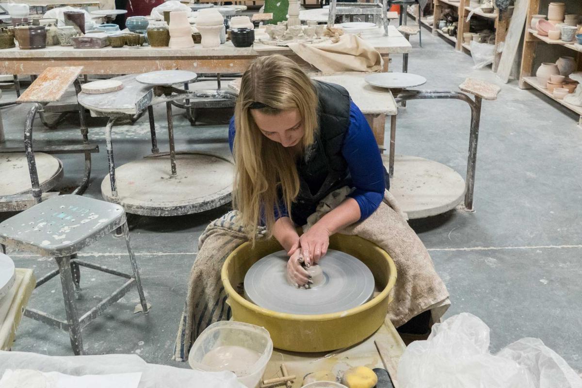 Student in wheel throwing class